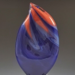 Photo of the Leadership Award trophy, a glass cube topped with a purple and orange teardrop shape.
