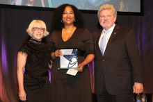 Kristina Newman-Scott receives the Selina Roberts Ottum Award in 2018. She is flanked by Americans for the Arts Board Chair Julie Muraco and CEO Robert L. Lynch.