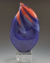 Photo of the Leadership Award trophy, a glass cube topped with a purple and orange teardrop shape.